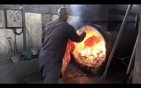 A worker incinerates medical waste at the Jaramogi Oginga Odinga Teaching and Referral hospital in Kisumu, Kenya